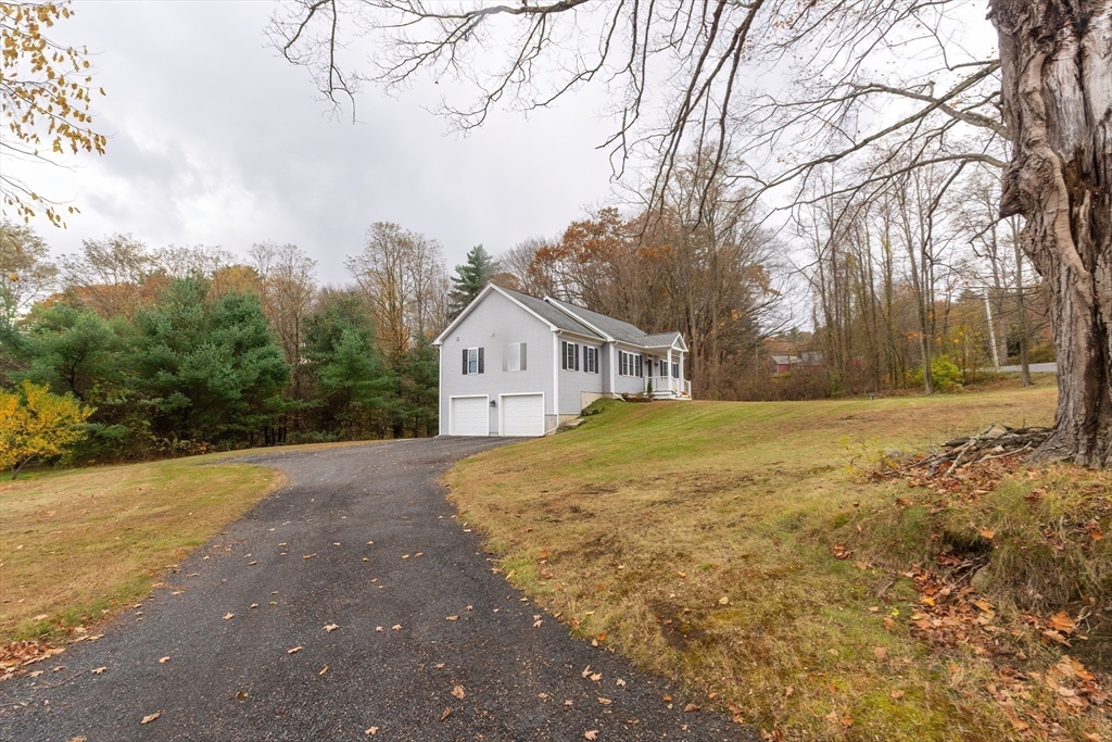 11 Shea Road West Brookfield, MA 01585 - Photo 5 of 42 a front view of house with yard and trees around