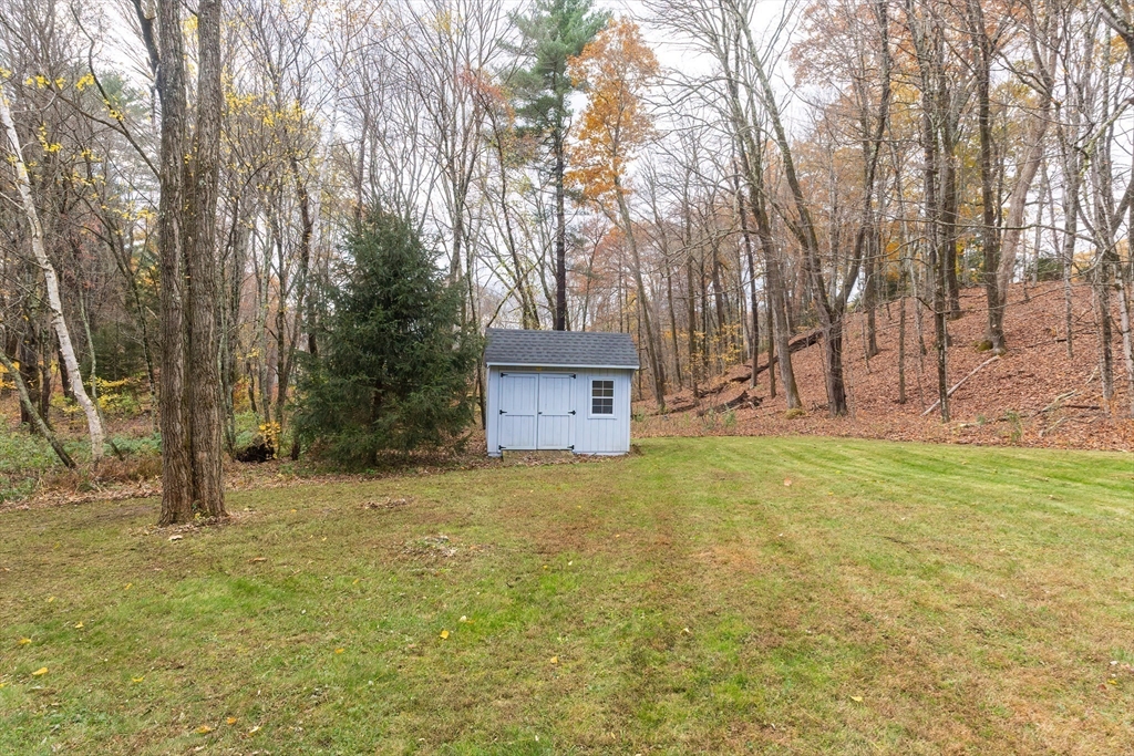 11 Shea Road West Brookfield, MA 01585 - Photo 8 of 42 a yellow house with trees in front of it