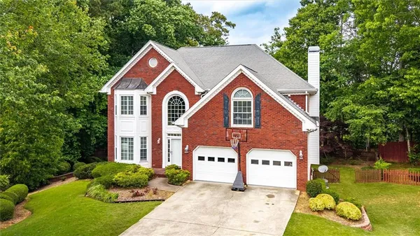 a front view of house with yard and green space