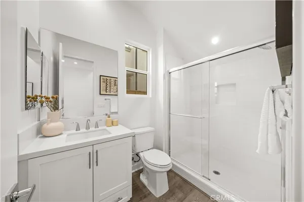 a bathroom with a sink toilet and shower