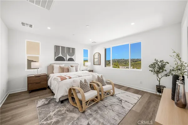 a bed room with a bed and a potted plant