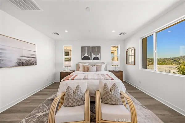 a bed sitting in a bedroom next to a window