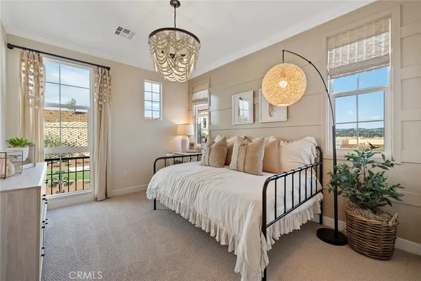 a bed sitting in a bedroom next to a window
