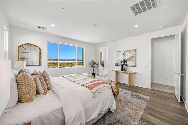 a bedroom with a large bed and a window