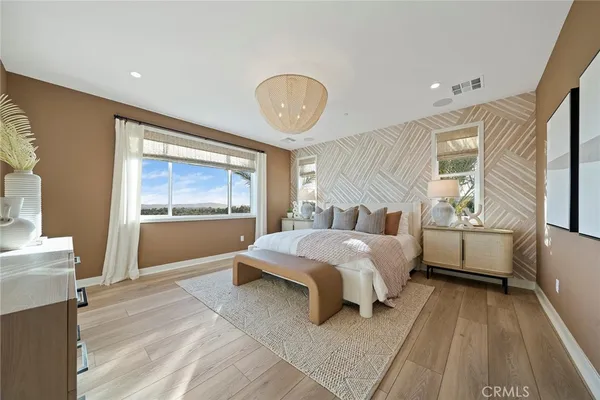 a bedroom with a large bed and a window