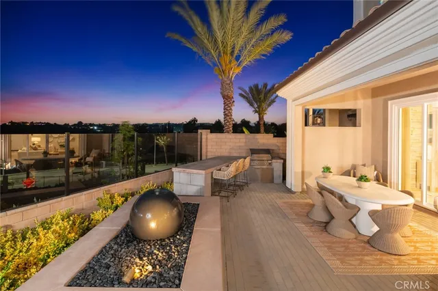 a view of a balcony with chairs and a potted plant