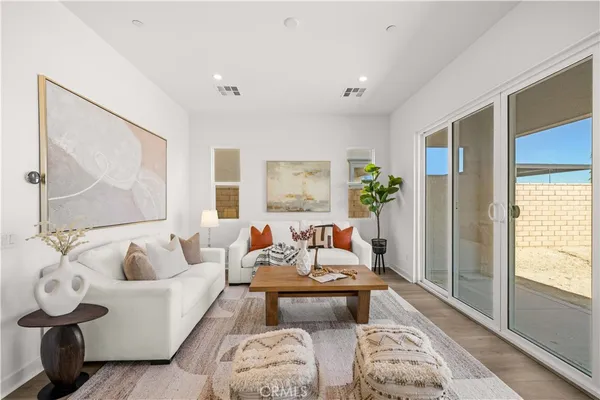 a living room with furniture and wooden floor