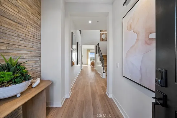 a view of a hallway with wooden floor and staircase