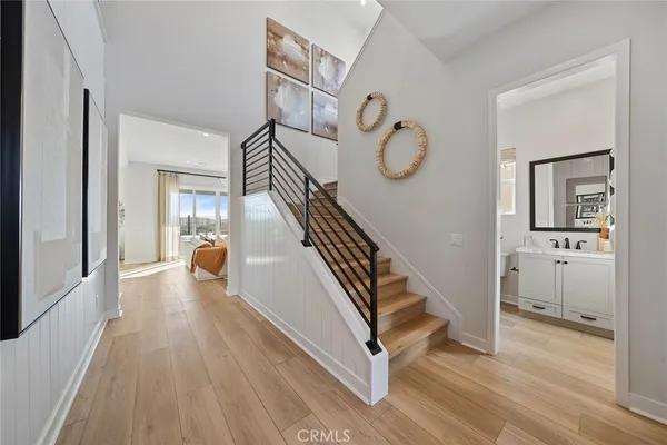 a view of a hallway with wooden floor and entryway