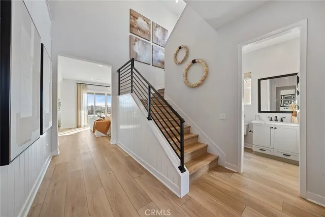 a view of a hallway with wooden floor and entryway