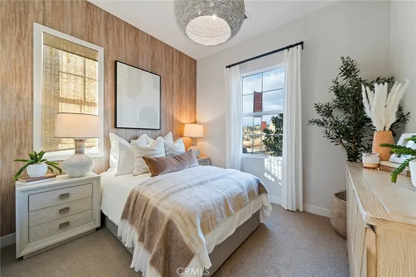 a bedroom with a bed and a potted plant