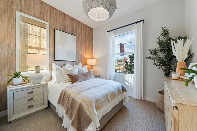 a bedroom with a bed and a potted plant