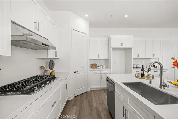 a kitchen with sink a stove and cabinets