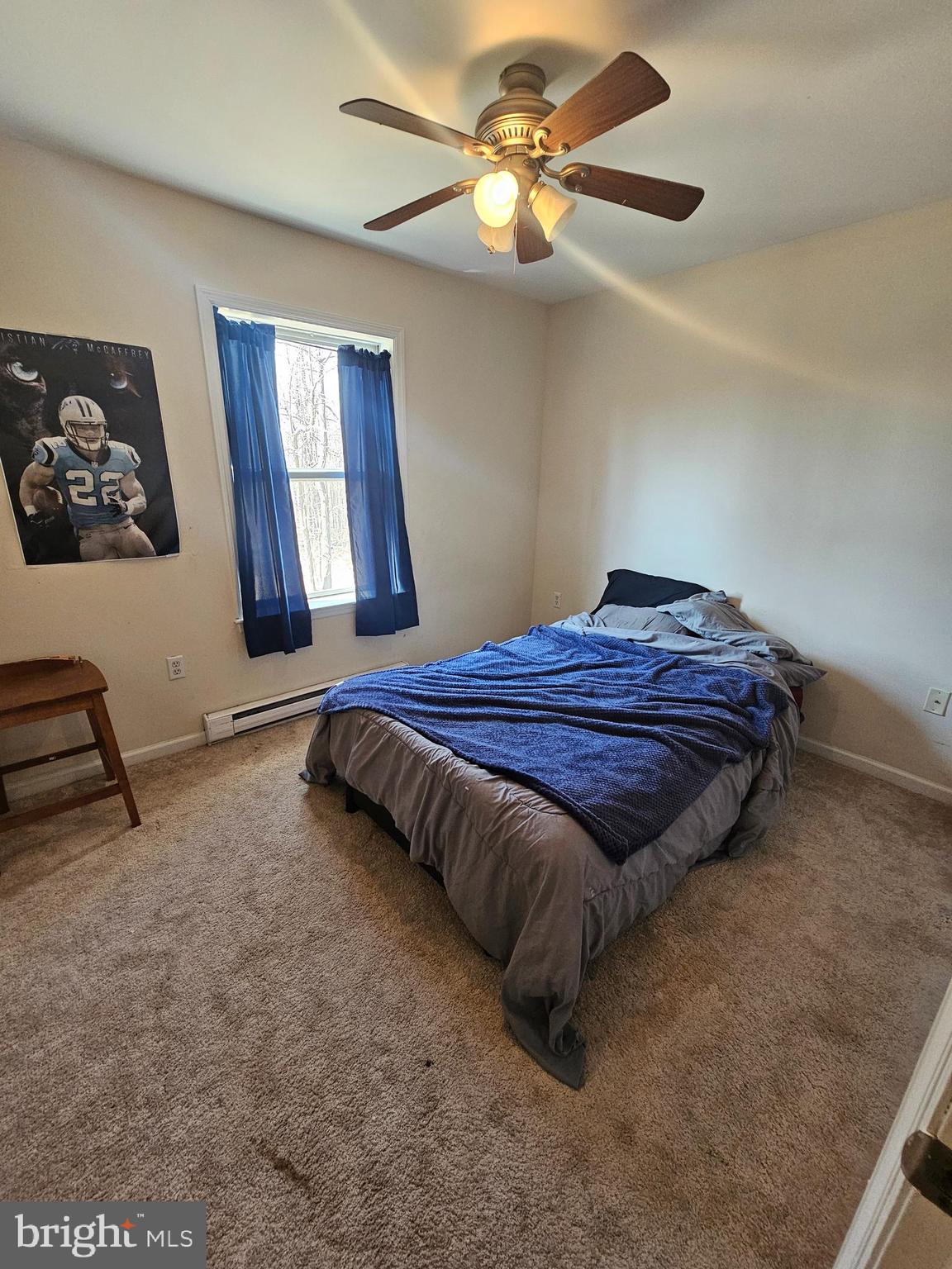 4229 Chestnut Ridge Road Grantsville, MD 21536 - Photo 13 of 25 a bedroom with a bed and a chandelier