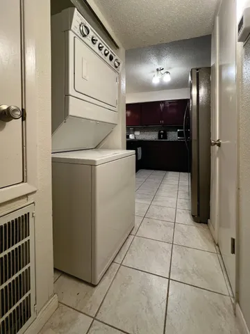a kitchen with refrigerator and cabinets