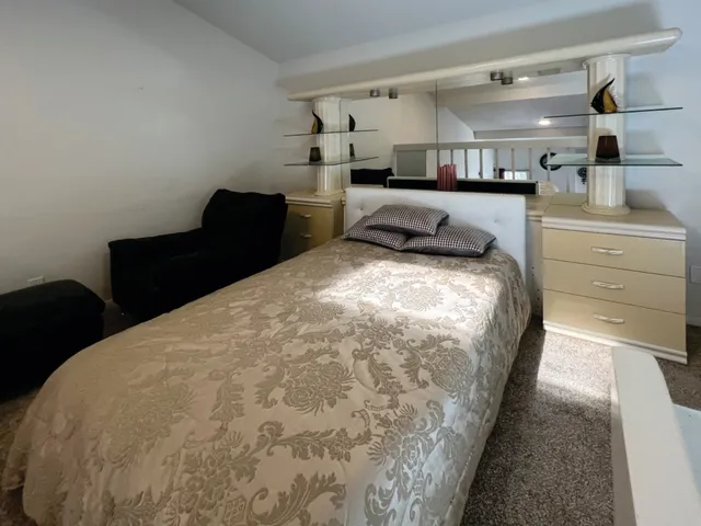 a large bed sitting in a bedroom and dresser