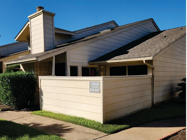 a back view of a house with a yard