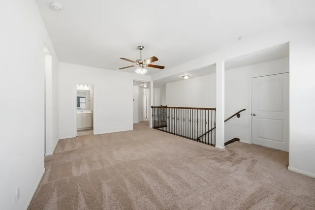 a view of a livingroom with a ceiling fan and window