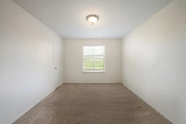 an empty room with windows and entrance