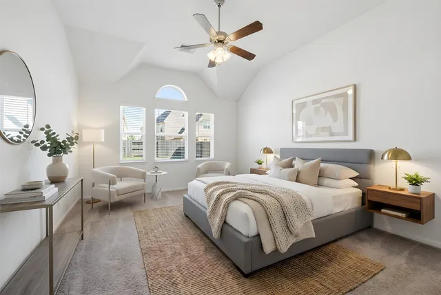 a spacious bedroom with a bed and a chandelier