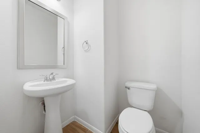 a bathroom with a sink a toilet and mirror