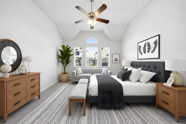 a bedroom with a large bed and a chandelier