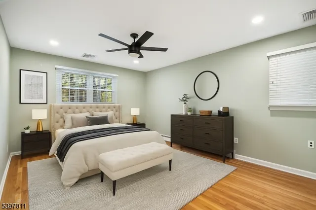 a view of a big room with wooden floor and windows