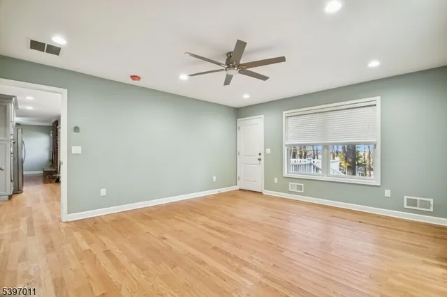 a spacious bedroom with a large bed and a chandelier