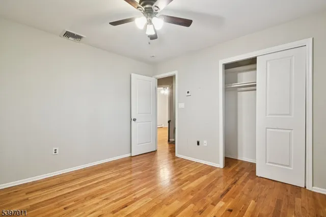 a bedroom with a bed mirror and a window