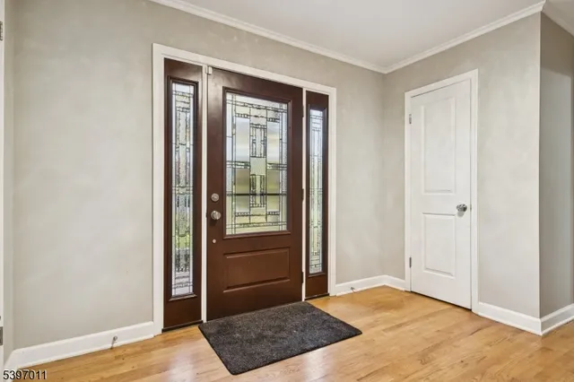 a backyard of a house with large trees and wooden fence