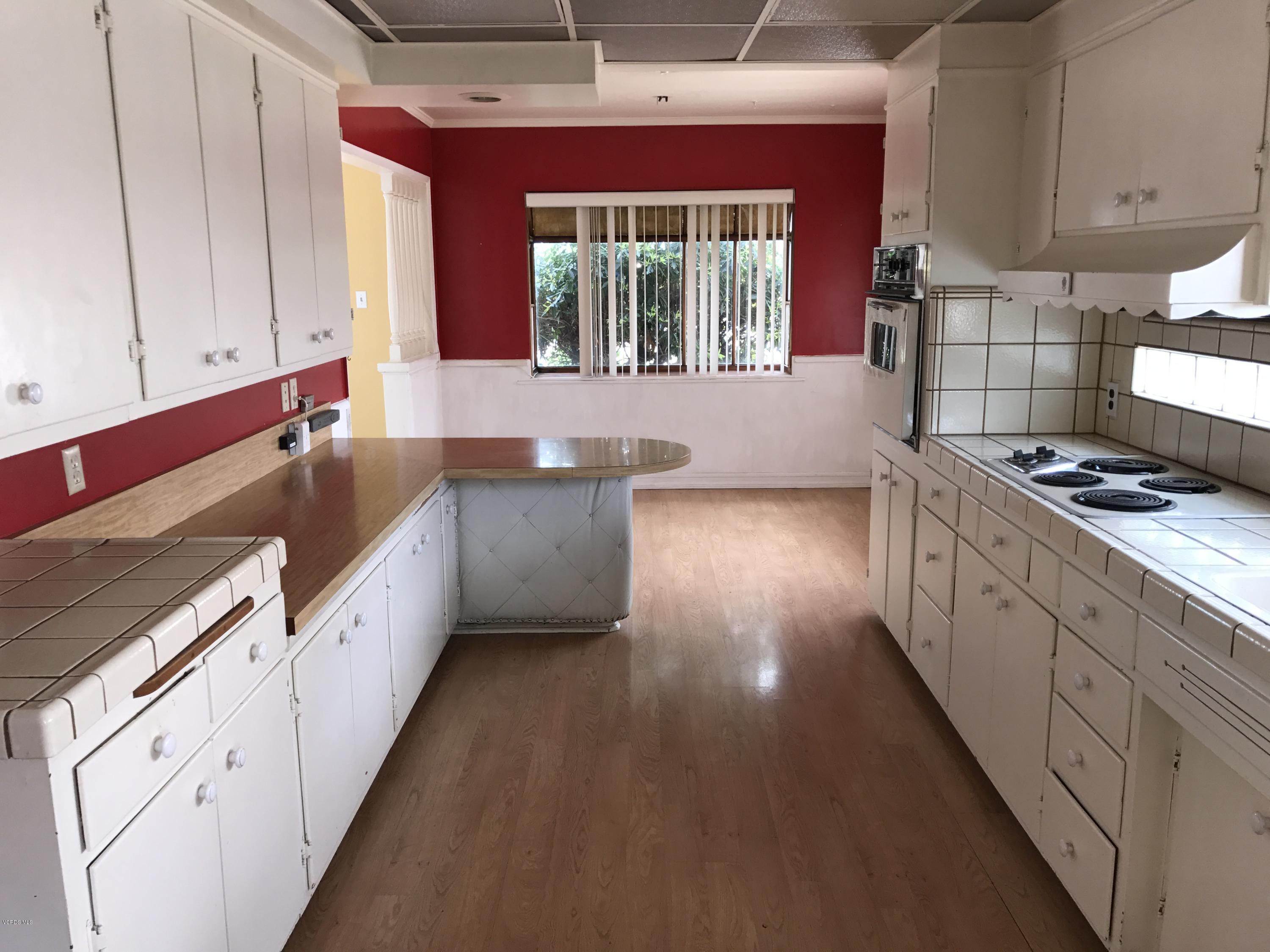 1660 Teal Club Road Oxnard, CA 93030 - Photo 3 of 18 a kitchen with stainless steel appliances granite countertop a stove a sink and a microwave