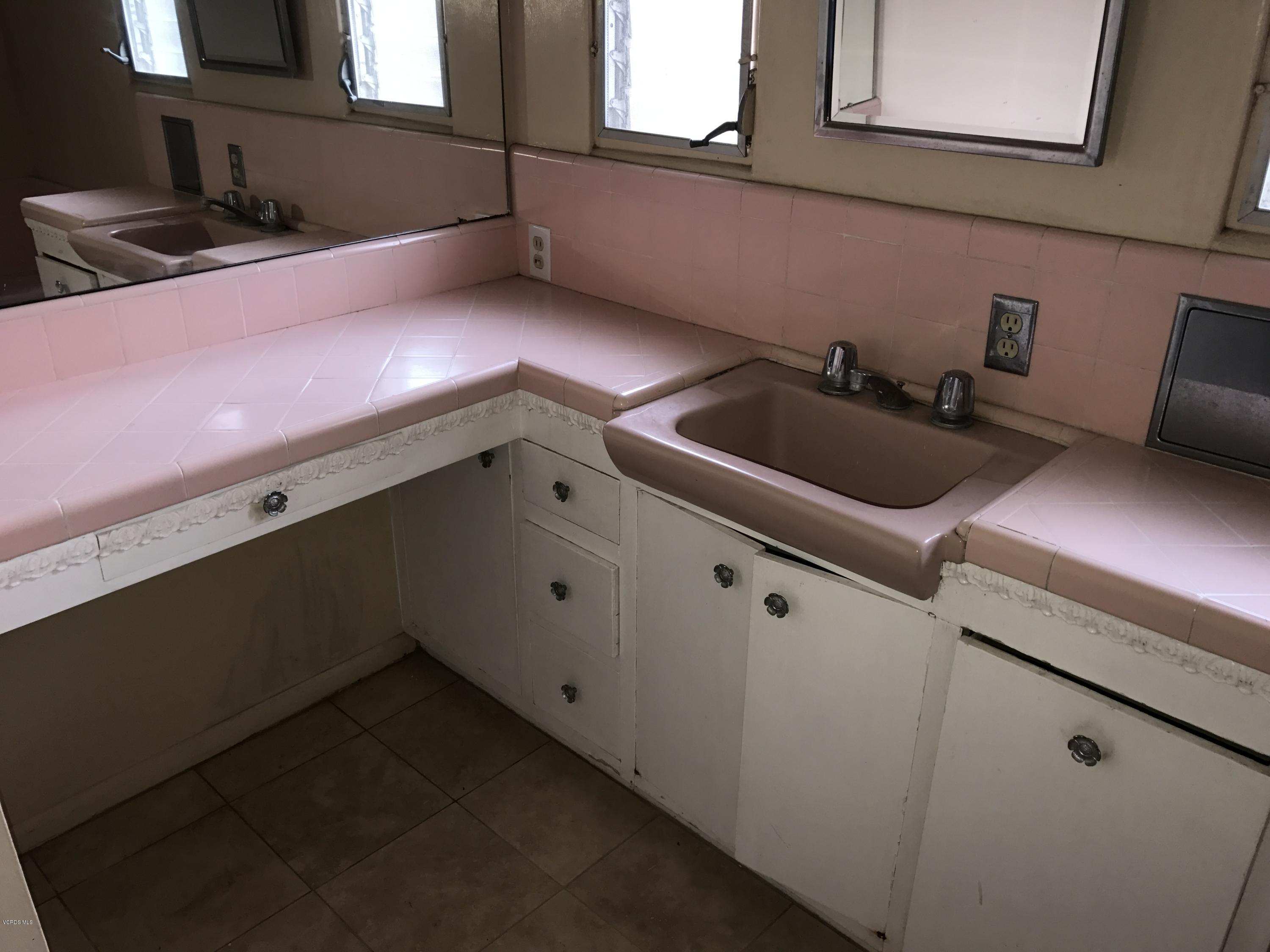 1660 Teal Club Road Oxnard, CA 93030 - Photo 5 of 18 a kitchen with a sink and cabinets