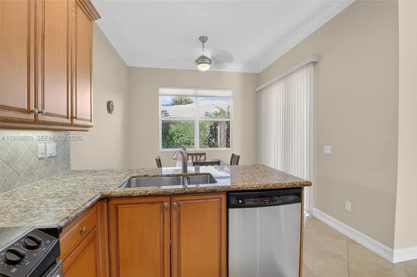 a kitchen with a table chairs and a refrigerator