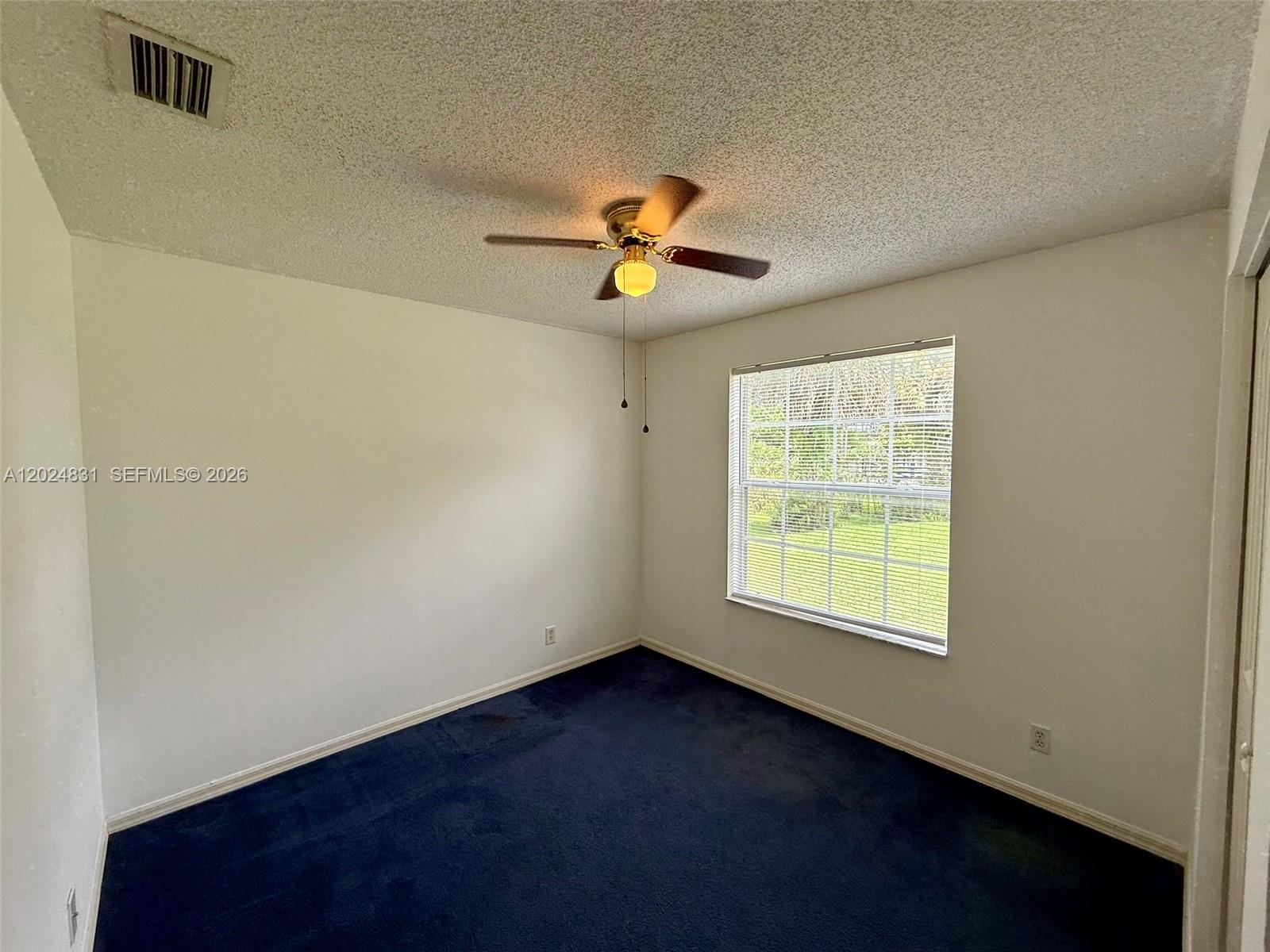 15819 76th Road North Loxahatchee, FL 33470 - Photo 41 of 45 an empty room with a window and a fan
