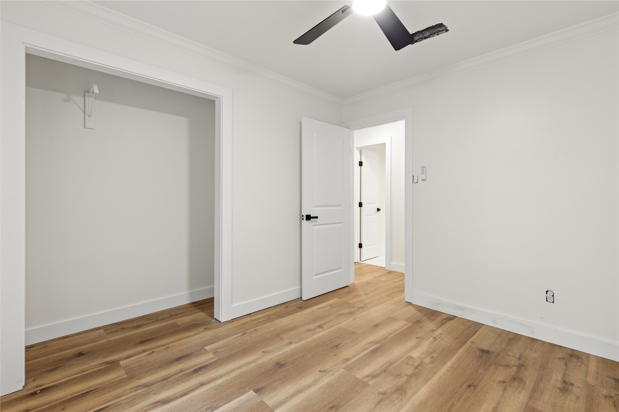 74 Robinson Road Huntsville, TX 77320 - Photo 21 of 33 an empty room with wooden floor and windows