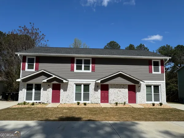 a front view of a house with a yard