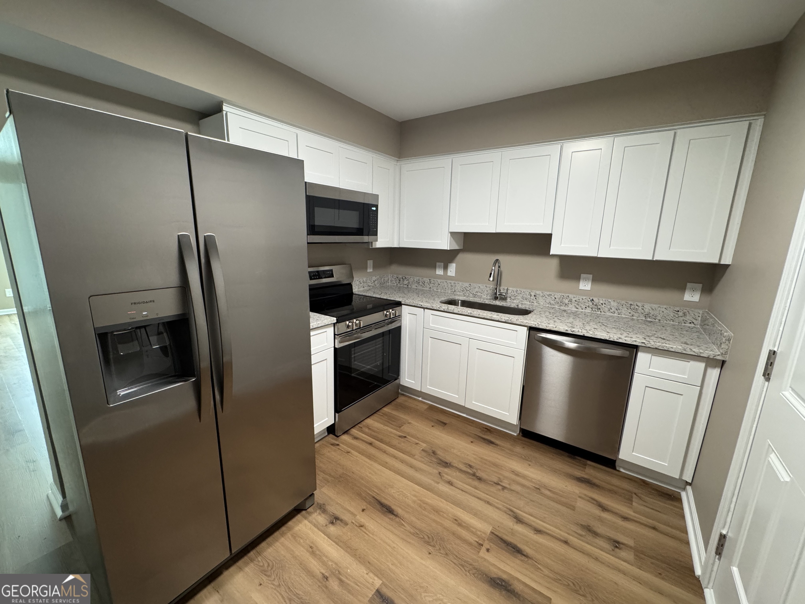 4235 Debby Street Columbus, GA 31907 - Photo 5 of 9 a kitchen with a refrigerator sink and stove top oven