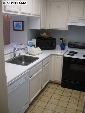 4401 Lower Honoapiilani Road, Unit A604 Lahaina, HI 96761 - Photo 11 of 29 a kitchen with a sink and cabinets