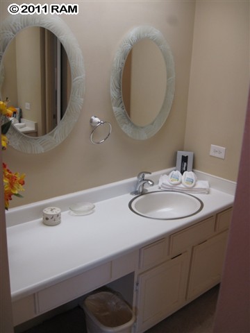 4401 Lower Honoapiilani Road, Unit A604 Lahaina, HI 96761 - Photo 15 of 29 a bathroom with a sink and a mirror