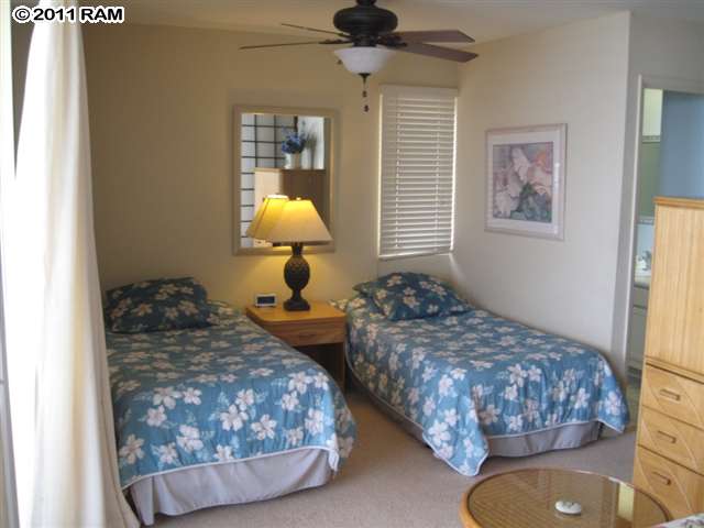 4401 Lower Honoapiilani Road, Unit A604 Lahaina, HI 96761 - Photo 18 of 29 a bedroom with two beds and painting on the wall