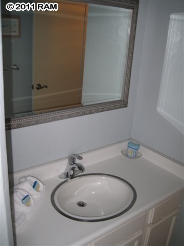 4401 Lower Honoapiilani Road, Unit A604 Lahaina, HI 96761 - Photo 22 of 29 a bathroom with a sink and a mirror