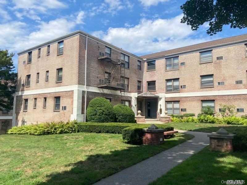 a front view of building with yard