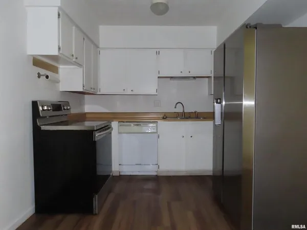 a kitchen with cabinets appliances and a counter space