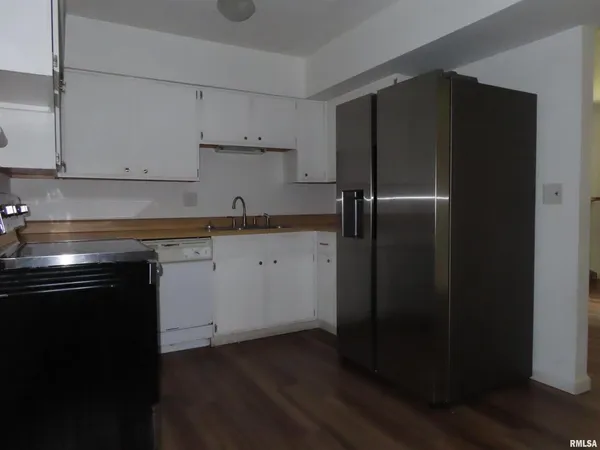 a kitchen with a sink stainless steel appliances and cabinets