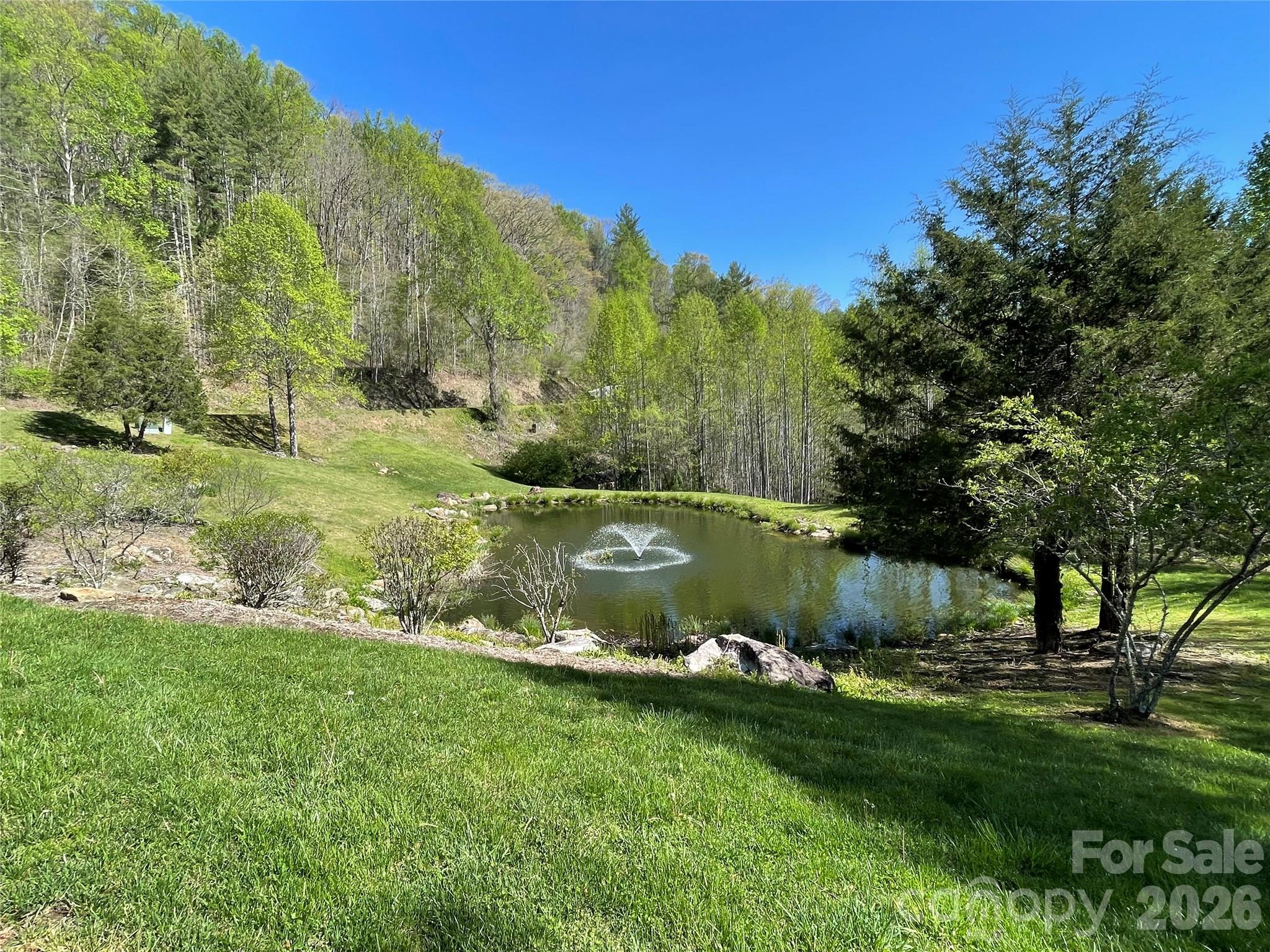 159 Songcatcher Court, Unit 159 Tuckasegee, NC 28783 - Photo 26 of 44 a view of a lake with a yard