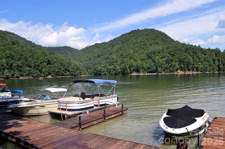 159 Songcatcher Court, Unit 159 Tuckasegee, NC 28783 - Photo 37 of 44 a view of a lake with a table and a chair