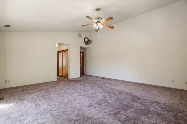 a view of a room with a ceiling fan