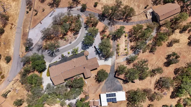 an aerial view of a house with a yard