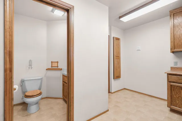 a white toilet sitting next to a bathroom sink