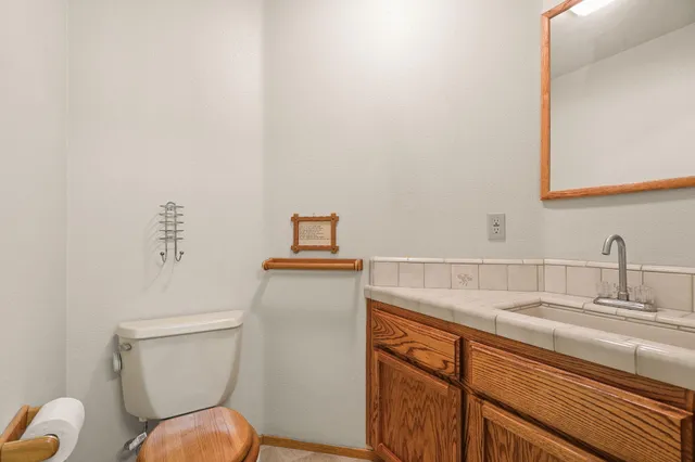 a bathroom with a toilet sink and mirror